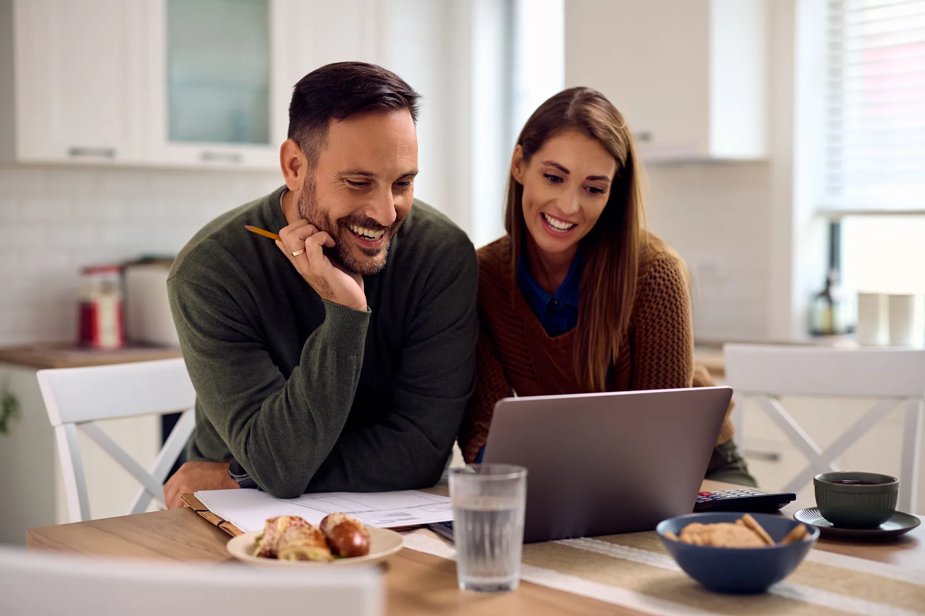 A couple reviewing marketplace plan costs on a laptop at home