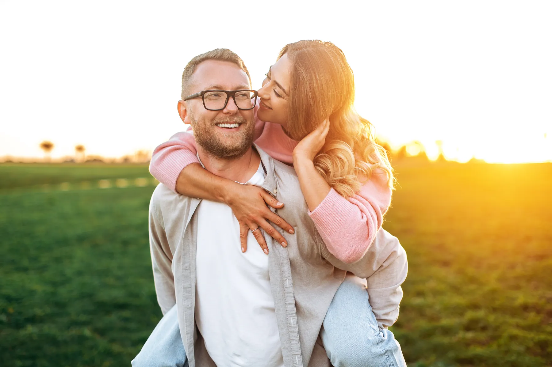 A couple together outdoors at sunset